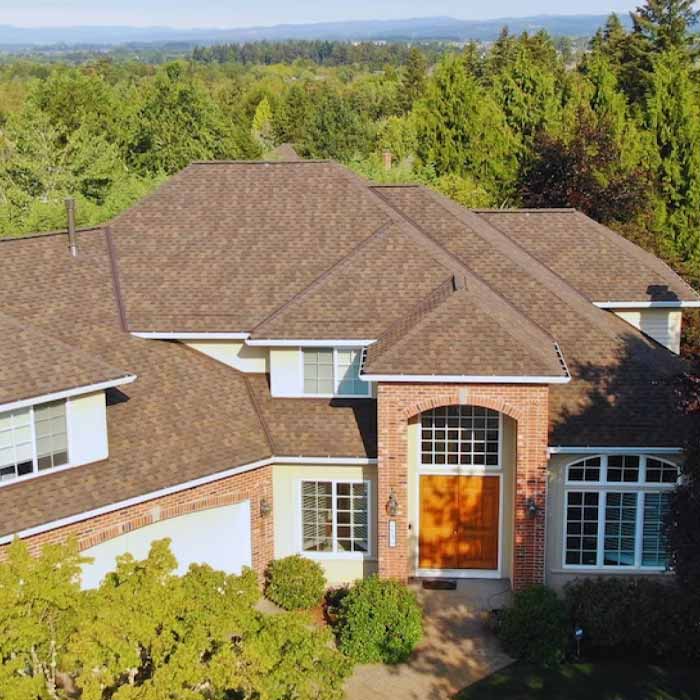 red brick home in a forest.